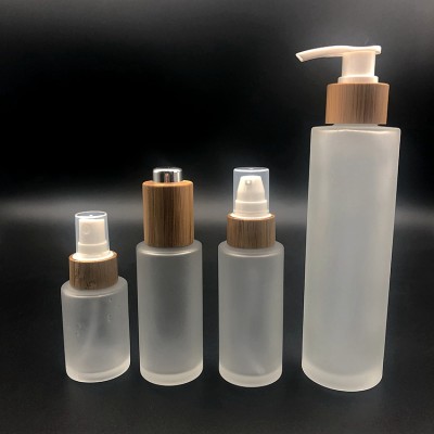 Luxury 30ml 50ml 100ml 150ml Clear Frosted Glass Lotion Bottle Container Bamboo Cap Spray Pump